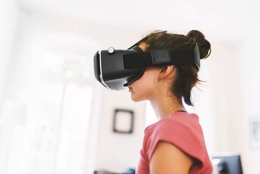 young girl watching on virtual reality glasses
