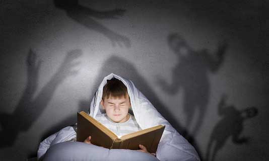 boy reading scary book=